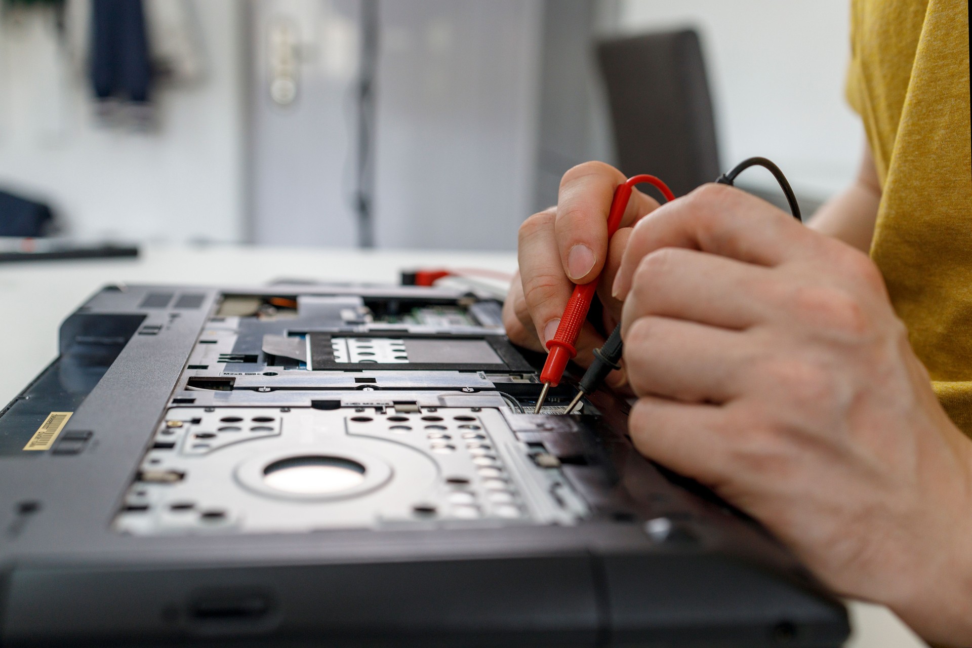 Close-up of a man working in laptop repair shop